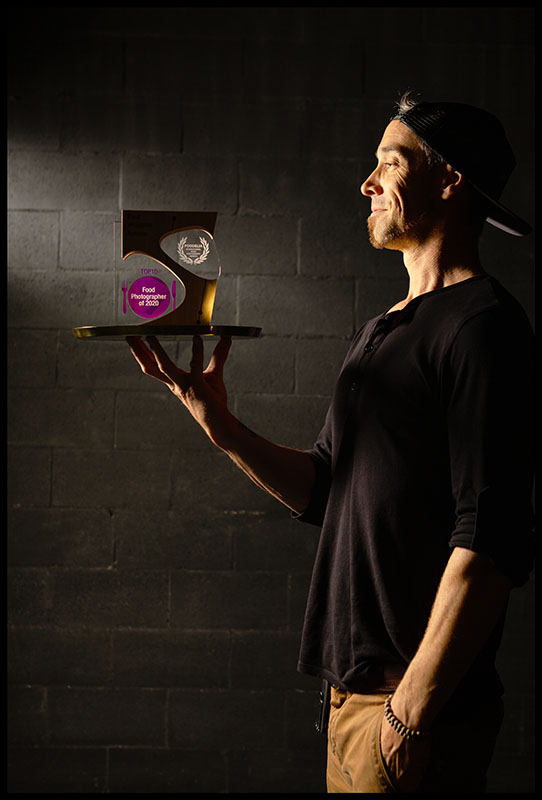 Paul Williams, Gold Coast commercial photographer, holding a food photography award